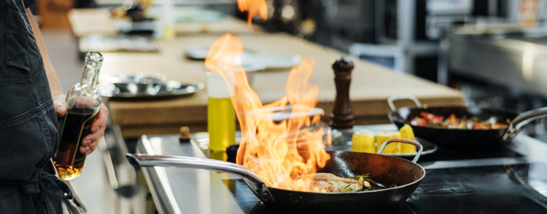side-view-chef-flambeing-dish-kitchen side-view-chef-flambeing-dish-kitchen